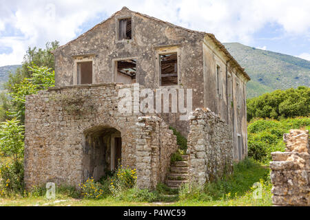 Ancient house built with concrete. Flowering plants growing in the ground. Wooden blocks falling from the ceiling. Ruins during medieval era. History  Stock Photo