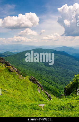 cliffs and grassy hills of Pikui mountain. beautiful view from the top. Borzhava ridge in the distance. lovely summer scenery with beautiful cloudscap Stock Photo