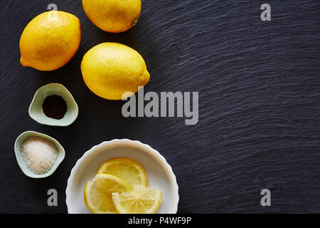 food blog lemons on dark slate worktop foodist bakery Stock Photo