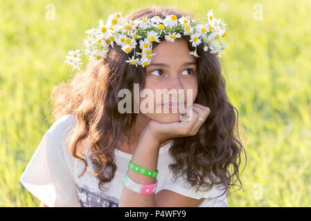 teenage girl with wreath from field Camomile on her head Stock Photo