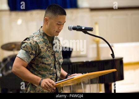 U.S. Navy LT Danny K. Cho, chaplain with 2d Combat Engineer Battalion, gives the invocation during 1st Lt. Garrett C. Cheung's memorial service on Camp Lejeune, N.C., May 9, 2017. 1st Lt. Cheung is survived by his parents, ALexander and Florence Cheung and his sister, Brigette. Stock Photo