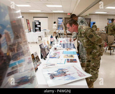 ROBINSON MANEUVER TRAINING CENTER, N. Little Rock, Ark.:—Sgt. 1st Class Daniel Disotell looks at an exibit during the Arkansas National Guard Equal Opportunity Office Diversity Day at Chappell Armory, Wednesday, May 10, 2017. The event was an opportunity to celebrate the diversity of the Total Force and embrace who we are and who we aren't regardless of race, gender, nationality, religion, or disability. More than 70 Soldiers were provided with information about diversity, a taste of cultural entertainment and ethnic foods and displays with information about Native Americans, Asians, African A Stock Photo