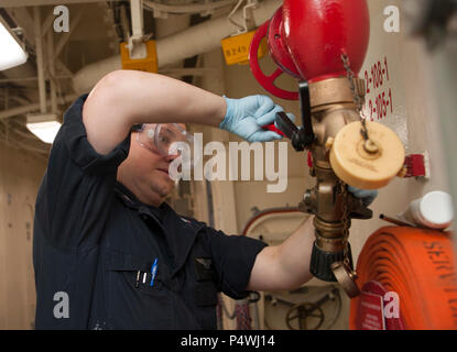 PACIFIC OCEAN (May 9, 2017) Aviation Structural Mechanic 3rd class Dustin Mitchell, a Las Vegas native, assigned to the amphibious assault ship USS America (LHA 6) conducts maintenance on a fire station. More than 1,800 Sailors and 2,600 Marines assigned to the America Amphibious Ready Group (ARG) and the 15th Marine Expeditionary Unit (MEU) are currently conducting a Composite Training Unit Exercise (COMPTUEX) off the coast of Southern California in preparation for the ARG’s deployment later this year. America ARG is comprised of America, the amphibious dock landing ship USS Pearl Harbor (LSD Stock Photo