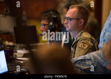 Senior Airman Zachary Hart, 137th Special Operations Wing information technology network specialist, prepares a video teleconference during the 2017 Air National Guard Leadership Conference at the National Center for Employee Development Conference Center, Norman, Okla., May 9, 2017. The leadership conference, attended by general officers, adjutant generals, wing commanders, command chiefs and directors of staff from across the 54 U.S. states and territories, focused on leading, protecting and supporting the 21st-century Guard Airman. Stock Photo