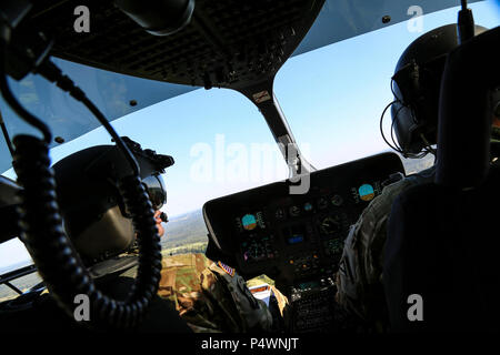 U.S. Soldiers of Joint Multinational Readiness Center (Operations Group) Falcon Observer Coach Trainer Team pilot a UH-72A Lakota helicopter while conducting flight operations during Saber Junction 17 at the Hohenfels Training Area, Germany, May 10, 2017. Saber Junction 17 is the U.S. Army Europe’s 2d Cavalry Regiment’s combat training center certification exercise, taking place at the Joint Multinational Readiness Center in Hohenfels, Germany, Apr. 25-May 19, 2017. The exercise is designed to assess the readiness of the regiment to conduct unified land operations, with a particular emphasis o Stock Photo