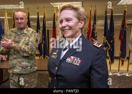 Brig. Gen. Edward J. Chrystal Jr., left, Assistant Adjutant General - Army for the New Jersey Army National Guard, applauds newly promoted Chief Warrant Officer 5 Michele Thomas during her promotion ceremony in the Hall of Remembrance at Joint Force Headquarters, New Jersey National Guard, located at Joint Base McGuire-Dix-Lakehurst, N.J., May 10, 2017. There are currently 128 warrant officers in the New Jersey Army National Guard, seven of them hold the rank of Chief Warrant Officer 5. The Army Warrant Officer Corps is comprised of more than 25,000 men and women of the active Army and reserve Stock Photo