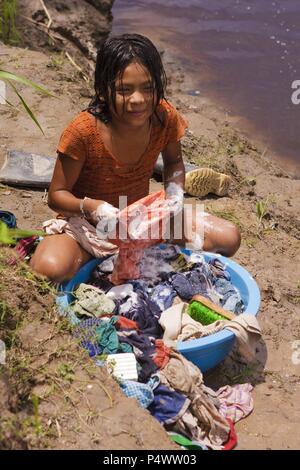 Girl washing clothes. Buenos Aires native community. Pacaya Samiria National Reserve. Amazon Basin. Loreto. Peru. Stock Photo
