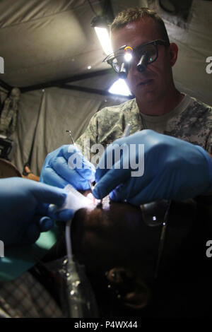 U.S. Army Maj. Aaron Taff, attached to the Wyoming National Guard Medical Detachment, sets a filling during a medical readiness event held in San Ignacio, Belize, May 08, 2017. This is the second of three medical events that are scheduled to take place during Beyond the Horizon 2017. BTH 2017 is a U.S. Southern Command-sponsored, Army South-led exercise designed to provide humanitarian and engineering services to communities in need, demonstrating U.S. support for Belize. Stock Photo