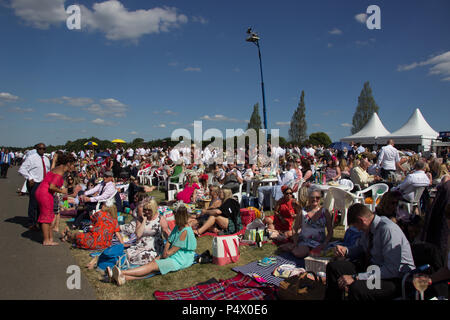 Large crowds of people sitting on grass in Windsor enclosure at Royal Ascot Stock Photo