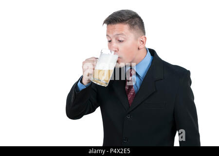 Young businessman in suit drinking beer from mug, isolated on white background Stock Photo