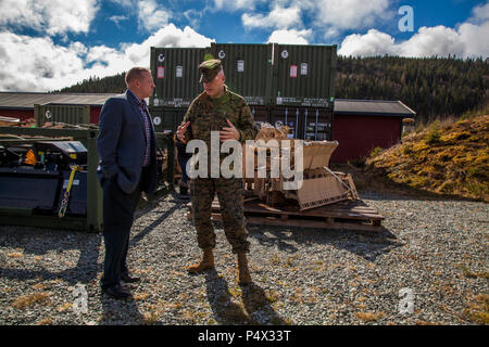 U.S. Marine Maj. Gen. Niel Nelson, commander of U.S. Marine Corps Forces Europe and Africa (MARFOREURAF), discusses the Marine Corps Prepositioning Program Norway (MCPP-N), with Lyle Layher, MARFOREURAF’s prepositioning officer, at an assembly area in Norway, May 9, 2017. By storing equipment in Norwegian caves, MCPP-N eliminates the need to deploy equipment from the United States for contingency operations which decreases the time required to prepare units. Stock Photo