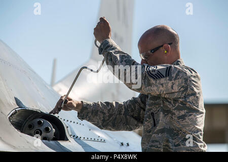 Senior Master Sgt. Eugene Gaspar, 301st Fighter Wing weapons manager, Naval Air Station Fort Worth Joint Reserve Base, Texas, performs post-flight maintenance on an F-16 Fighting Falcon’s 20 mm multibarrel cannon at Hill Air Force Base, Utah, May 9. Aircraft and Airmen from Naval Air Station Fort Worth Joint Reserve Base, Moody AFB, Georgia and Hickam AFB, Hawaii, participated in Combat Hammer, a twice annual precision-guided air-to-ground weapons evaluation exercise conducted at Hill AFB and the Utah Test and Training Range. Stock Photo