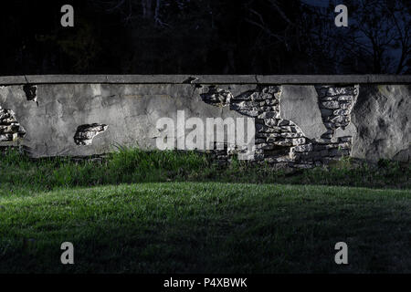 Old Stone Wall Crumbling At Night Stock Photo