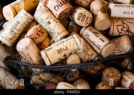 old cork stoppers of French wines in a wire basket Stock Photo