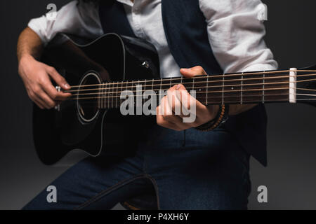cropped shot of man playing acoustic guitar Stock Photo