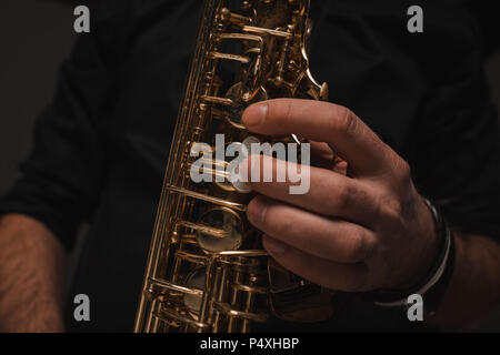 cropped shot of jazzman playing saxophone Stock Photo
