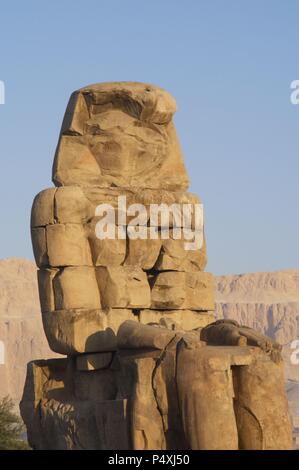 Colossi of Memnon. Stone statues depicting pharaoh Amenhotep III (14th century B.C.) in a seated position. Eastern colossus. Eighteenth Dynasty. New Kingdom. Luxor. Egypt. Stock Photo