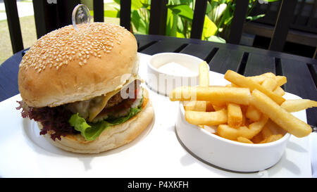 PULAU LANGKAWI, MALAYSIA - APR 5th 2015: Cheeseburger and french fries on a white plate in a luxury hotel restaurant Stock Photo