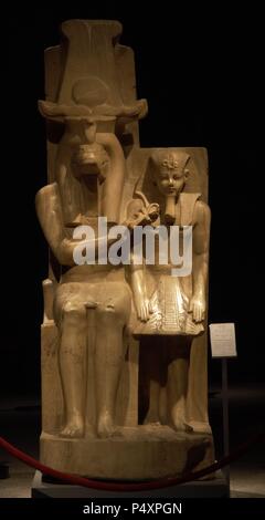 Statue of Amenhotep III (Neb-Maat-Ra) and Sobek c.1390-1352 BC. Carved from Calcite (Egyptian Alabaster). Found in the Sobek temple at Dahamsha. Sobek is seated in a human form with the crocodile head and  his right hand holds the Ankh giving life to the youthful Amenhotep III.  The King is wearing the Nemes headdress, with the uraeus and royal beard. 18th Dynasty. New Kingdom. Luxor Museum. Egypt. Stock Photo