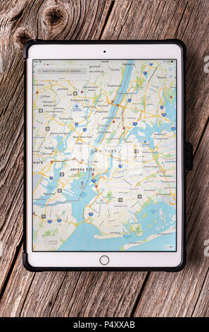 Ipad pro 10.5 inches with New York City map on a wooden table. Stock Photo
