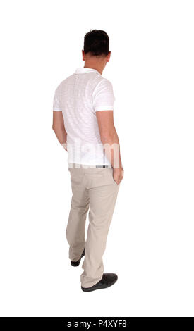 A tall handsome middle age man standing in a beige slacks and white t-shirt  with his hands in his pocket, from the back, isolated for white backgroun Stock Photo