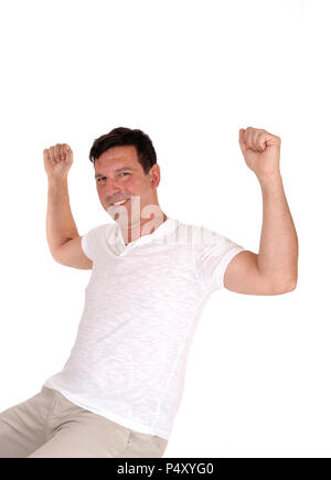 A handsome happy man lifting up his fists and smiling for victory over his success and celebrates win, isolated for white background Stock Photo