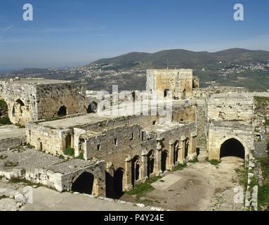 Syria. Krak des Chevaliers. Castle built in the twelfth century by the Knights Hospitaller during the Crusades to the Holy Land. Room of receptions and gallery. Ruins. Stock Photo