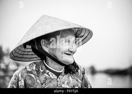 Old friendly woman with vietnamese straw hat Stock Photo