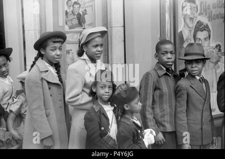Children in Front of Moving Picture Theater, Easter Sunday Matinee, 'Black Belt', Chicago, Illinois, USA, Edwin Rosskam for Office of War Information, April 1941 Stock Photo