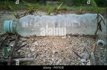 Empty single use plastic bottle washed up on beach Stock Photo