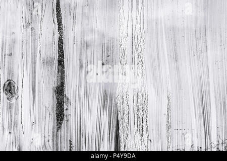 abstract hand painted glass surface background. whitewash paint blots on greenhouse windows Stock Photo