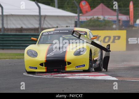 Dalton on Tees, England, 23 June 2018. Fin Green removes two course markers driving in the qualifying session of the Ginetta Junior Championship for Elite Motorsport. Credit: Colin Edwards/Alamy Live News. Stock Photo