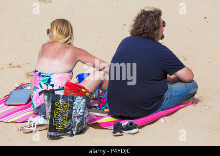 Bournemouth, Dorset, UK. 23rd June 2018. UK weather: crowded beaches on a lovely hot sunny day as visitors head to the seaside to make the most of the sunshine as temperatures rise for the heatwave. Couple sitting on beach in the sun Stock Photo