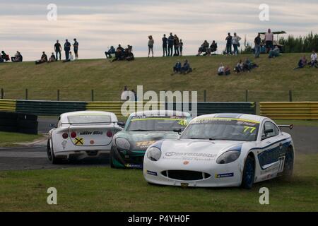 Dalton on Tees, England, 23 June 2018. Rookies Jamie Osborne, number 46, of WDE and Conner Garlick, number 77, a privateer driving on the grass to avoid a spinning car driven by rookie Ben O’Hare in Round 11 of the Ginetta Junior Championship at Croft. Credit: Colin Edwards/Alamy Live News. Stock Photo