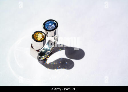 Original white gold ring with yellow and blue sapphire Stock Photo