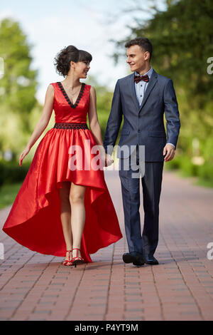 Elegant young couple having a walk in the park Stock Photo - Alamy