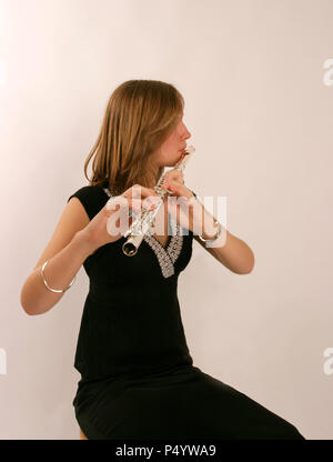 Flute in playing position, showing enbouchure and fingers on keys.  Model release - Anna Marchant Stock Photo