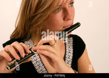 Piccolo in plkaying position showing fingers on keys Model release - Anna Marchant Stock Photo