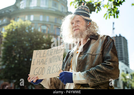 Homeless street man asking people for any help Stock Photo