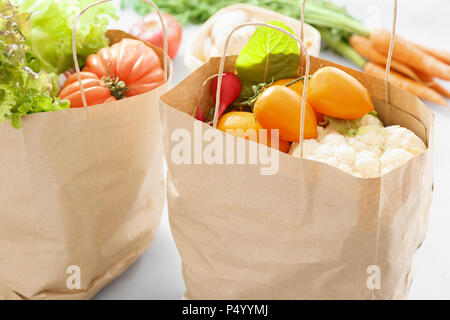 Two paper bag of healthy food on gray background Stock Photo