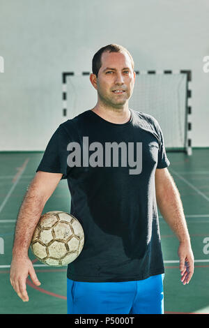 Portrait of indoor soccer player holding the ball Stock Photo