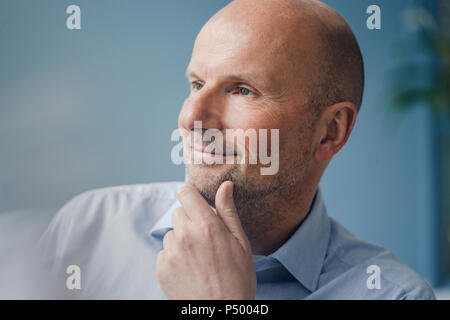 Portrait of smiling mature businessman looking sideways Stock Photo