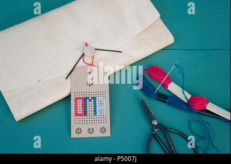 Tag, brodery for grandmother, cross stitch, wooden folder, scissors, embroidery cotton Stock Photo