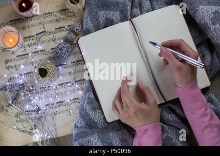 Hands of woman writing in notebook Stock Photo