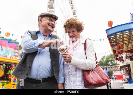 Senior couple having fun together on fair Stock Photo
