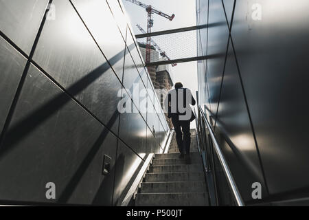Businessman walking on staircase in the city Stock Photo