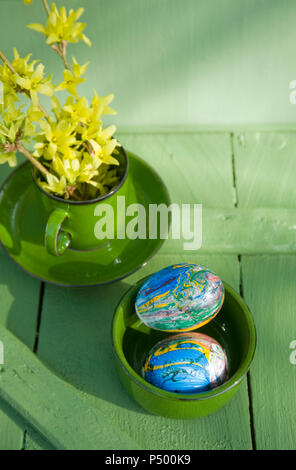 Easter eggs painted with nail varnish in bowl Stock Photo