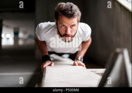 Portrait of man doing push-ups Stock Photo