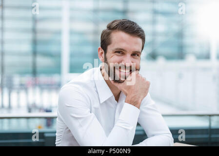 Portrait of smiling young businessman Stock Photo