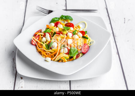 Zoodles with spaghettis, tomatoes and mini mozzarella cheese balls Stock Photo